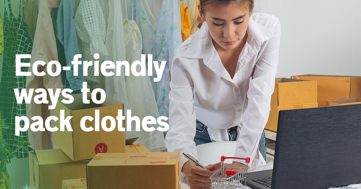 A lady writing in front of a laptop and showing cloths packaging.